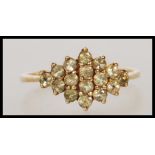 A stamped 375 9ct gold cluster ring set with round cut green stones to the head. Weight 2.5g. Size