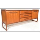 A retro 20th Century G Plan style teak wood sideboard / credenza, flared top over a central bank