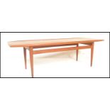 A mid century believed Danish long john coffee / occasional table. Of rectangular form with shaped