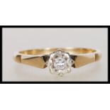 A hallmarked 9ct gold and diamond solitaire ring being illusion set with a brilliant cut diamond.