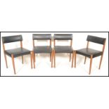 A set of four vintage retro 20th Century Danish dining chairs, faux leather overstuffed seat pad and
