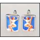 A pair of contemporary gentlemans silver and enamel cufflinks having enamel pictorial erotic lady