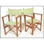 A pair of late 20th century teak wood steamer chairs / garden chairs that fold up and extend