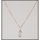 An 18ct yellow gold pear shaped diamond necklace pendant being set to an 18ct gold back chain, the