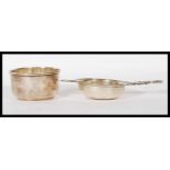A silver hallmarked tea strainer and bowl combination. Pierced bowl with shaped handles.
