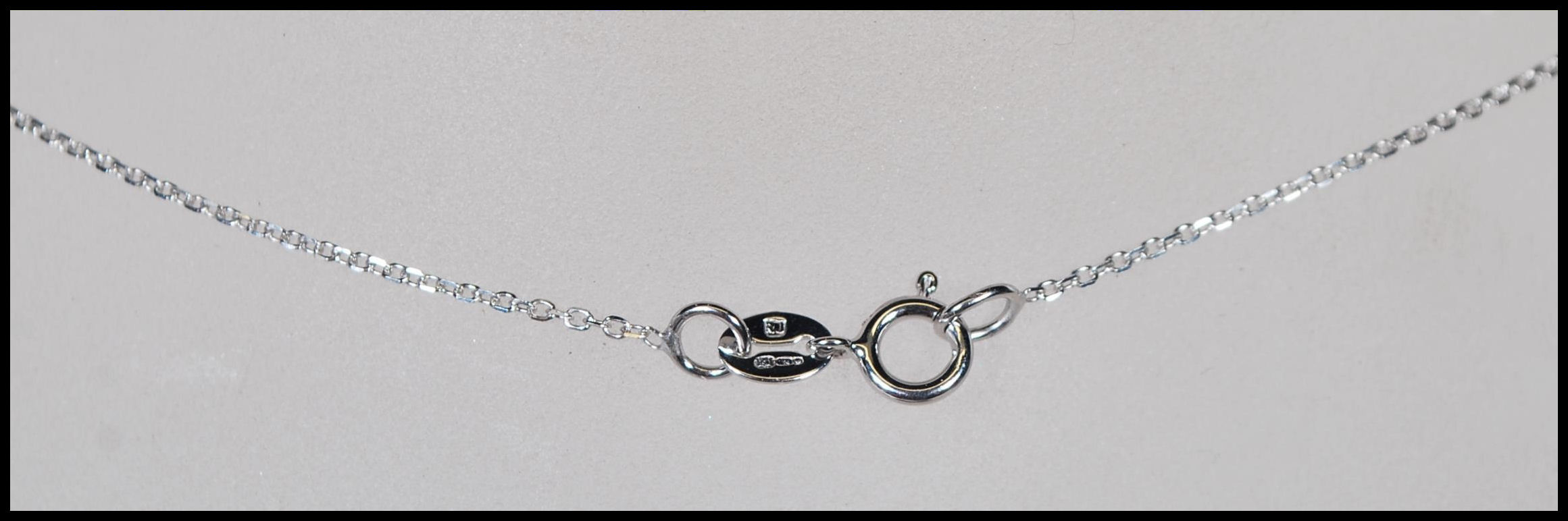 An 18ct white gold, aquamarine and diamond set necklace pendant set to a gold back chai. The central - Image 5 of 5