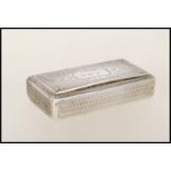 A 20th Century continental silver snuff box of rectangular form having engine turned decoration with