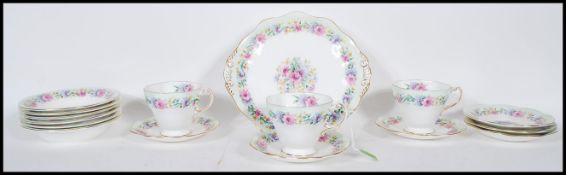 A part tea service by Foley bone china in the Cornflower pattern having floral sprays and gilt rims.