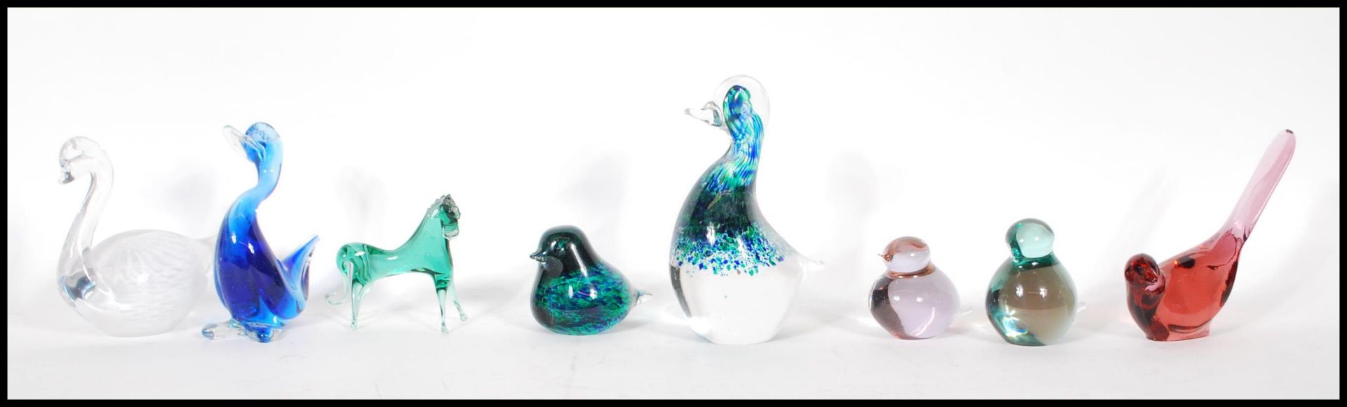 A collection of 20th Century studio glass paperweights in the form of birds to include two