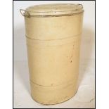 A vintage mid 20th Century industrial metal flour bin, hinged lid to the oval flour bin body.