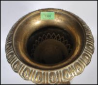 A early 20th Century brass jardiniere planter having flared top with embossed decoration with the