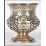 A 19th Century Victorian silver hallmarked goblet having embossed and engraved floral decoration,