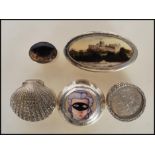 A collection of silver and silver plated pill boxes to include a stamped 925 silver shell box, a