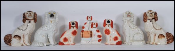 A collection of 19th century Victorian Staffordshire fireside dogs / spaniels to include coloured