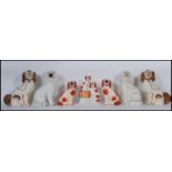 A collection of 19th century Victorian Staffordshire fireside dogs / spaniels to include coloured