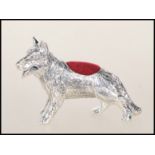 A silver German Shepherd Dog pin cushion. The dog with red baize cushion to its back. Total weight