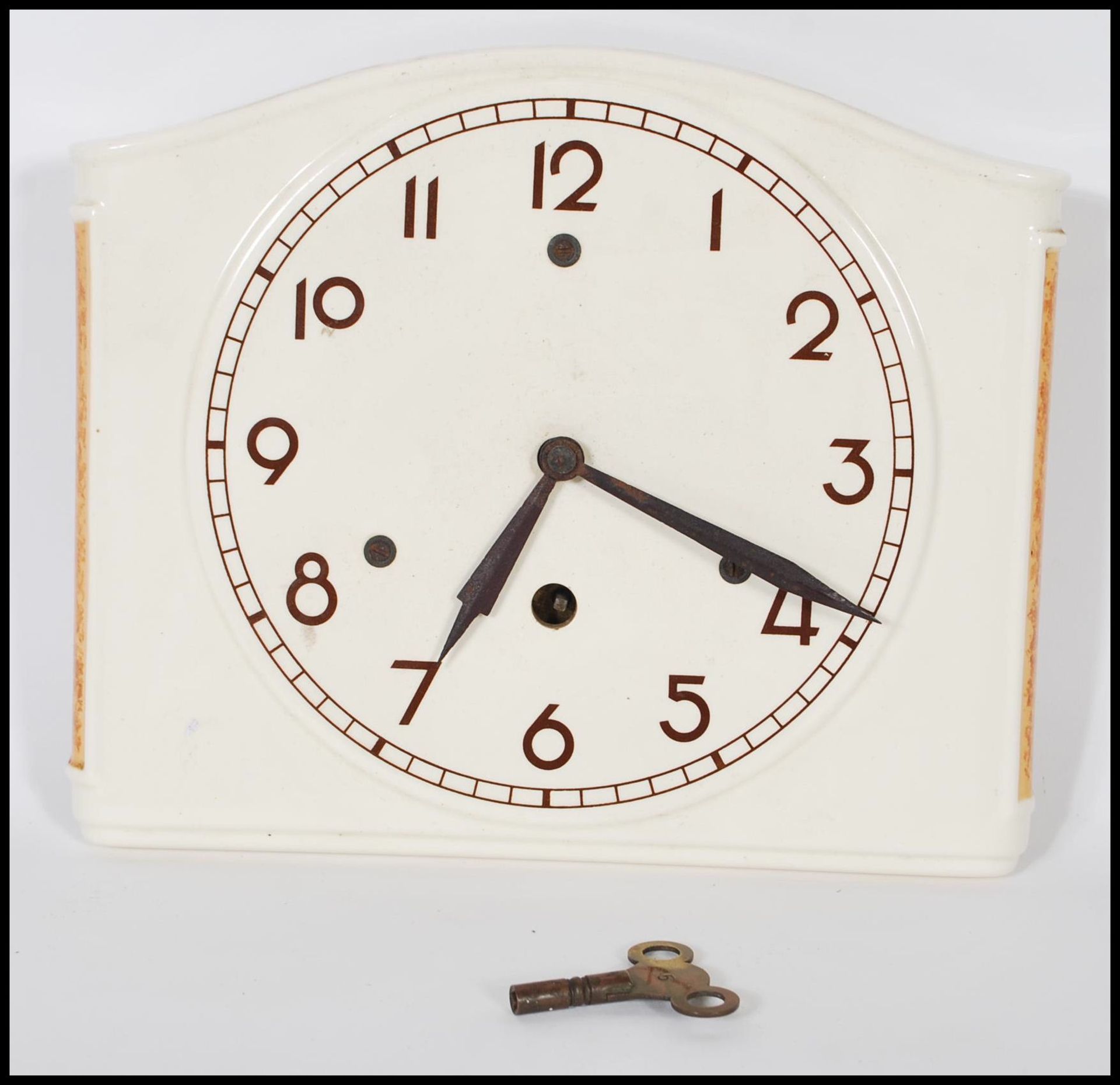 An early 20th Century Art Deco ceramic wall clock