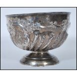 A late Victorian silver hallmarked rose bowl with scalloped decoration being raised on a terraced