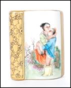 A 20th Century Chinese paperweight in the form of a book having an erotic scene with gilt details.