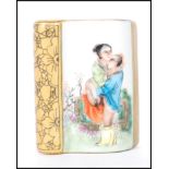 A 20th Century Chinese paperweight in the form of a book having an erotic scene with gilt details.