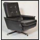 A retro 20th century 1960's black swivel recliner