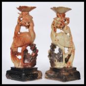 A pair of 19th century Chinese soapstone phoenix birds. Each depicted perched on a branch with