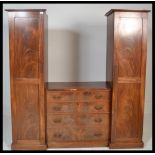 A 19th Century flamed mahogany sentry box triple wardrobe / compactum.  The centre with chest of