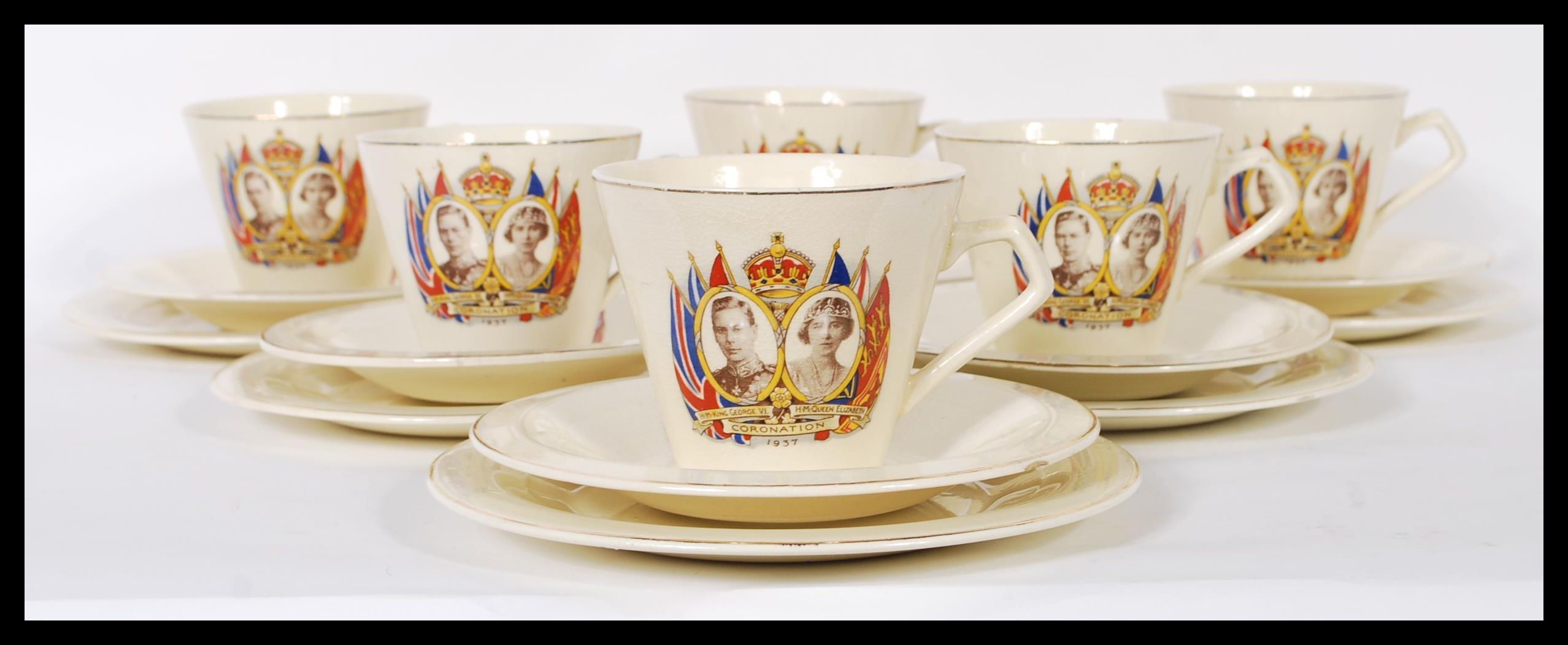 A set of six early 20th Century ceramic tea cup trio's commemorating the Coronation of George VI and