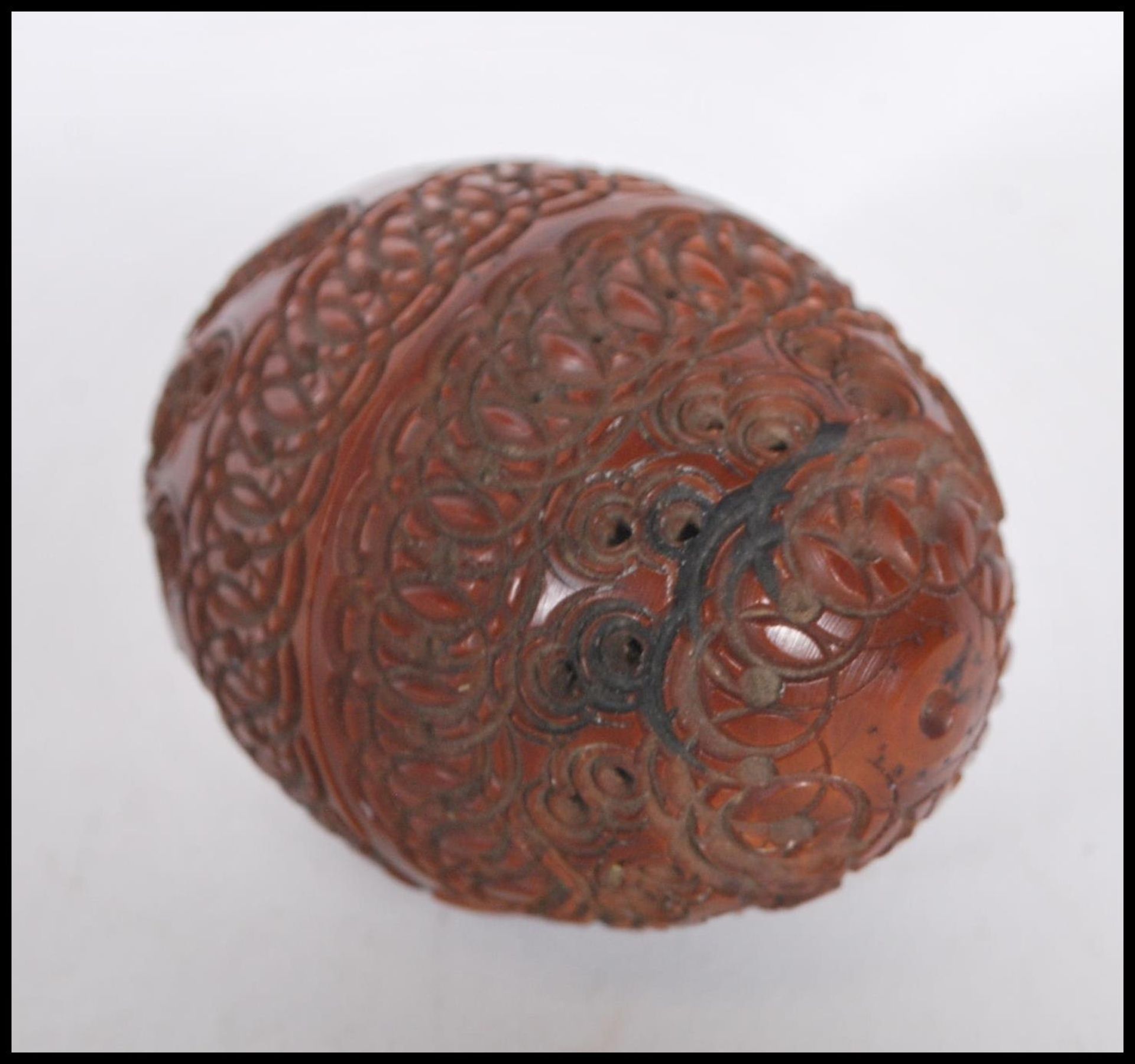 A 20th Century carved coquilla nut pomander case being carved with concentric circle patterning with - Image 3 of 4