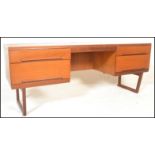 A retro 20th Century teak wood twin pedestal kneehole desk, having a configuration of drawers raised