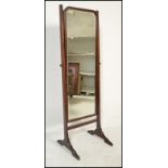 An Edwardian mahogany cheval - ladies full length bedroom dressing mirror. Raised on a mahogany