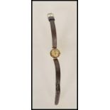 A 9ct gold cased vintage Omega ladies cocktail wrist watch having a metallic dial with gilt baton