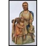 A 19th century polychrome believed French wooden sculpture of the good shepherd seated with