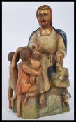 A 19th century polychrome believed French wooden sculpture of the good shepherd seated with