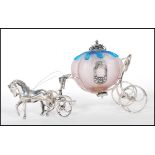 A stamped 925 silver ornament in the form of a cinderella horse drawn carriage having a pink and