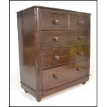 A 19th Century Victorian pine scrumble finish chest of two over three graduating drawers, turned
