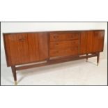 A mid 20th Century teak wood sideboard / credenza, by Ernst Gomme for G-Plan central bank of three