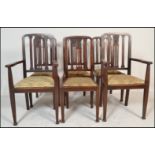 A set of six early 20th Century Edwardian mahogany dining chairs two being carvers, the rail back