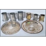 A collection of tankards to include a selection of pewter, some having hammered decoration, and