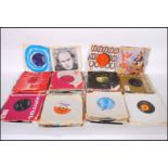 A collection of 45rpm vinyl 7" records by various artists and genres to include The Beatles, Get