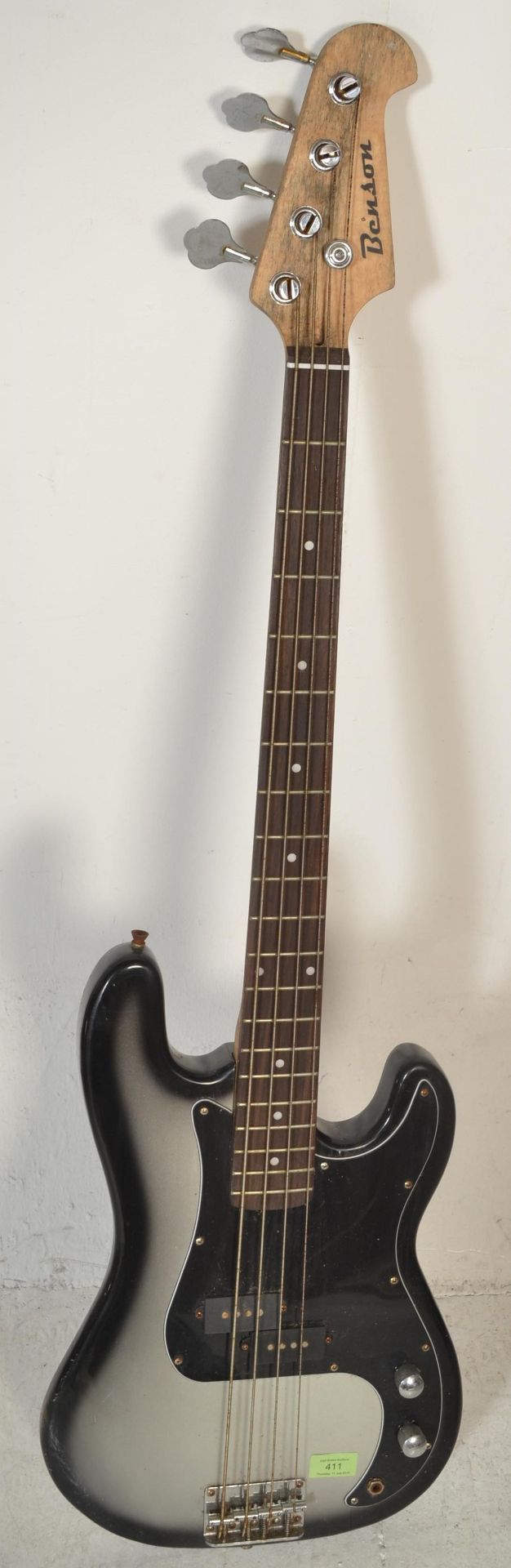 A 20th Century Benson four string Precision style Bass guitar, finished with a black body.