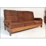 A retro 1960's Danish inspired teak wood day bed sofa. The turned legs supporting a fold down bed