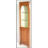 A good quality antique style yew wood corner cabinet raised on bracket feet  with single cupboard