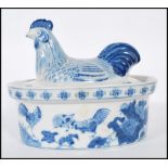 A Chinese blue and white chicken crock pot having cover in the form of a chicken with foliat