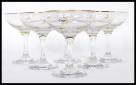 A set of six vintage retro 20th Century Babycham glasses raised on circular bases with gilt rim