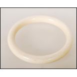 A late 19th / early 20th Century ivory bangle of typical circular form. Interior measures approx 6.