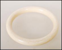 A late 19th / early 20th Century ivory bangle of typical circular form. Interior measures approx 6.
