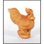 A 20th century Japanese boxwood Netsuke in the form of a rooster being signed to the base also being