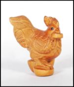 A 20th century Japanese boxwood Netsuke in the form of a rooster being signed to the base also being