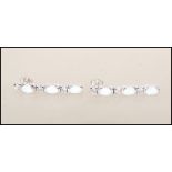 A pair of Art Deco style silver and opalite ladies drop earrings. Each interspersed with CZ oval cut